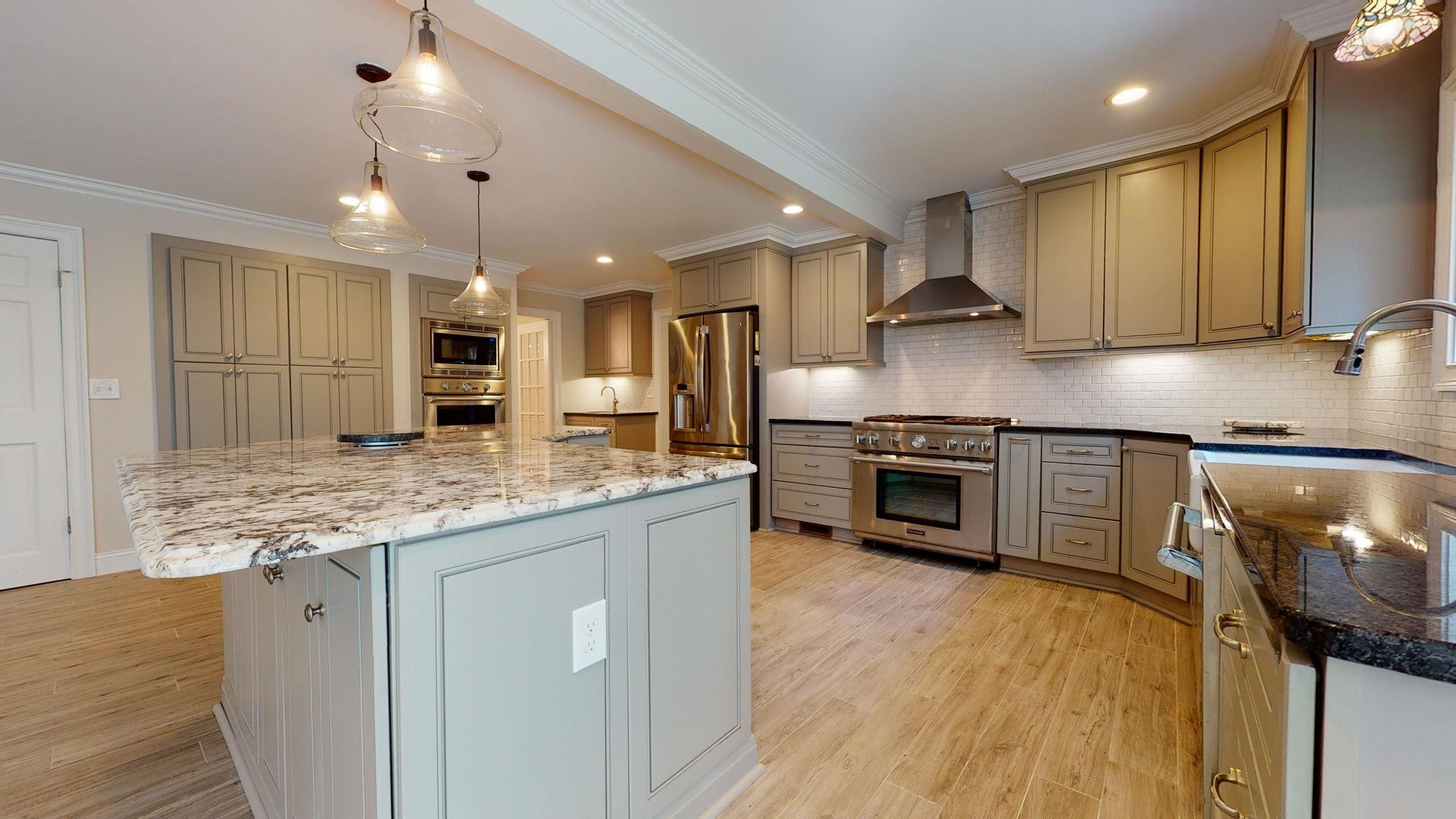 5308 Craig Road Durham, NC 27712 - Photo 18 of 46 a kitchen with stainless steel appliances granite countertop a stove a sink and a refrigerator
