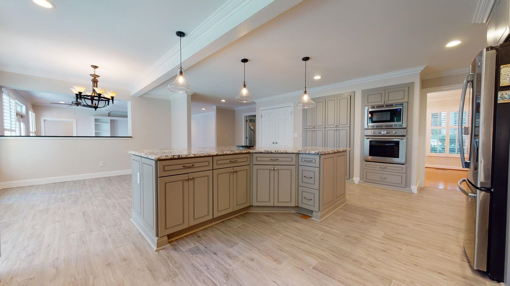 5308 Craig Road Durham, NC 27712 - Photo 20 of 46 a large kitchen with kitchen island a sink stainless steel appliances and cabinets