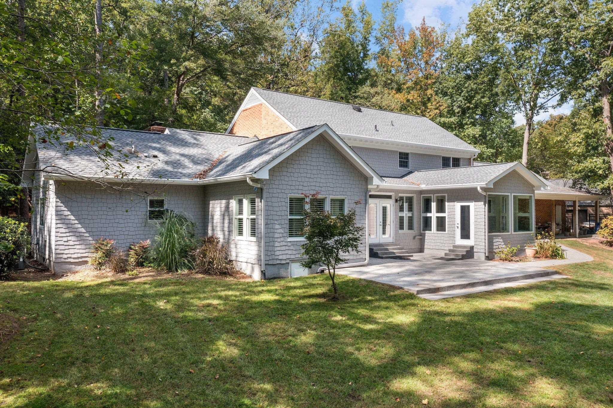 5308 Craig Road Durham, NC 27712 - Photo 3 of 46 a front view of a house with a yard patio and fire pit