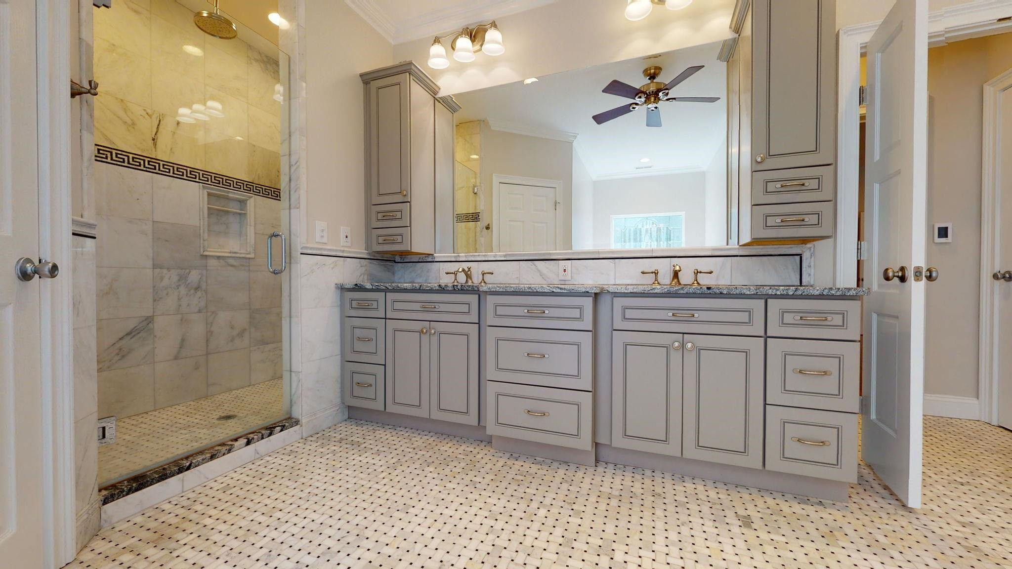5308 Craig Road Durham, NC 27712 - Photo 32 of 46 a bathroom with a sink a toilet a large mirror and shower