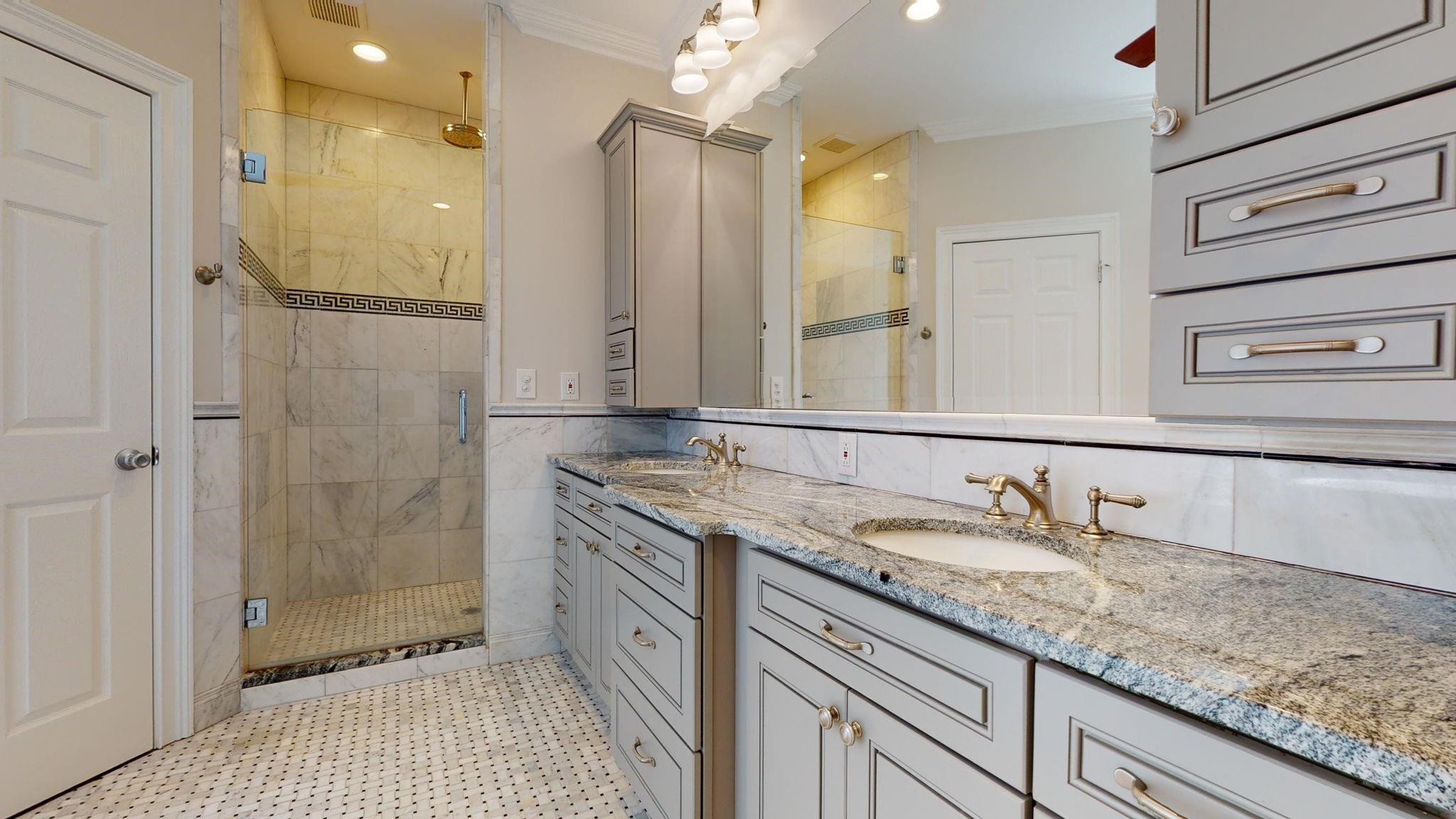 5308 Craig Road Durham, NC 27712 - Photo 34 of 46 a spacious bathroom with a granite countertop sink a mirror and a shower