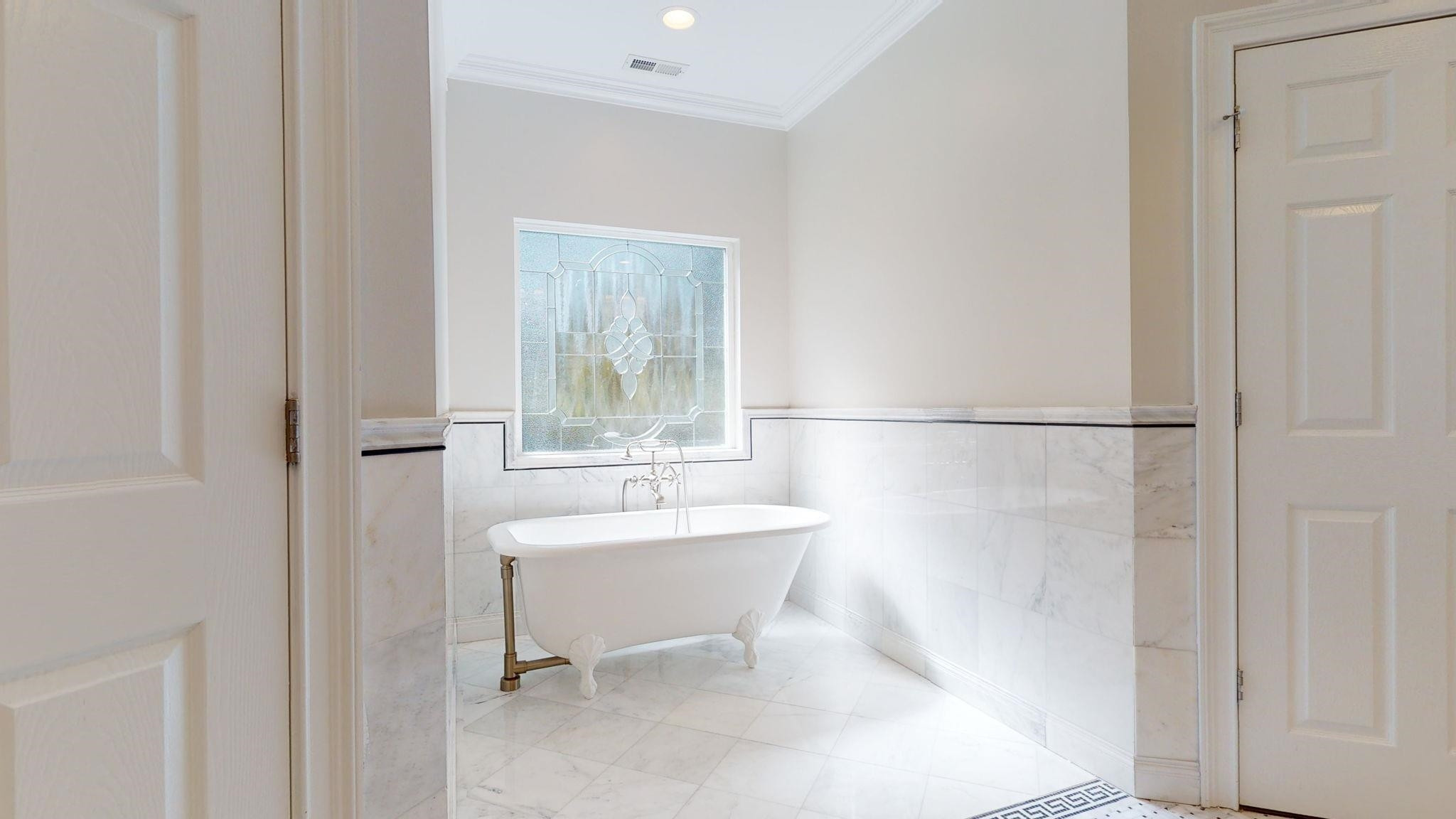 5308 Craig Road Durham, NC 27712 - Photo 36 of 46 a bathroom with a sink a mirror and a bathtub