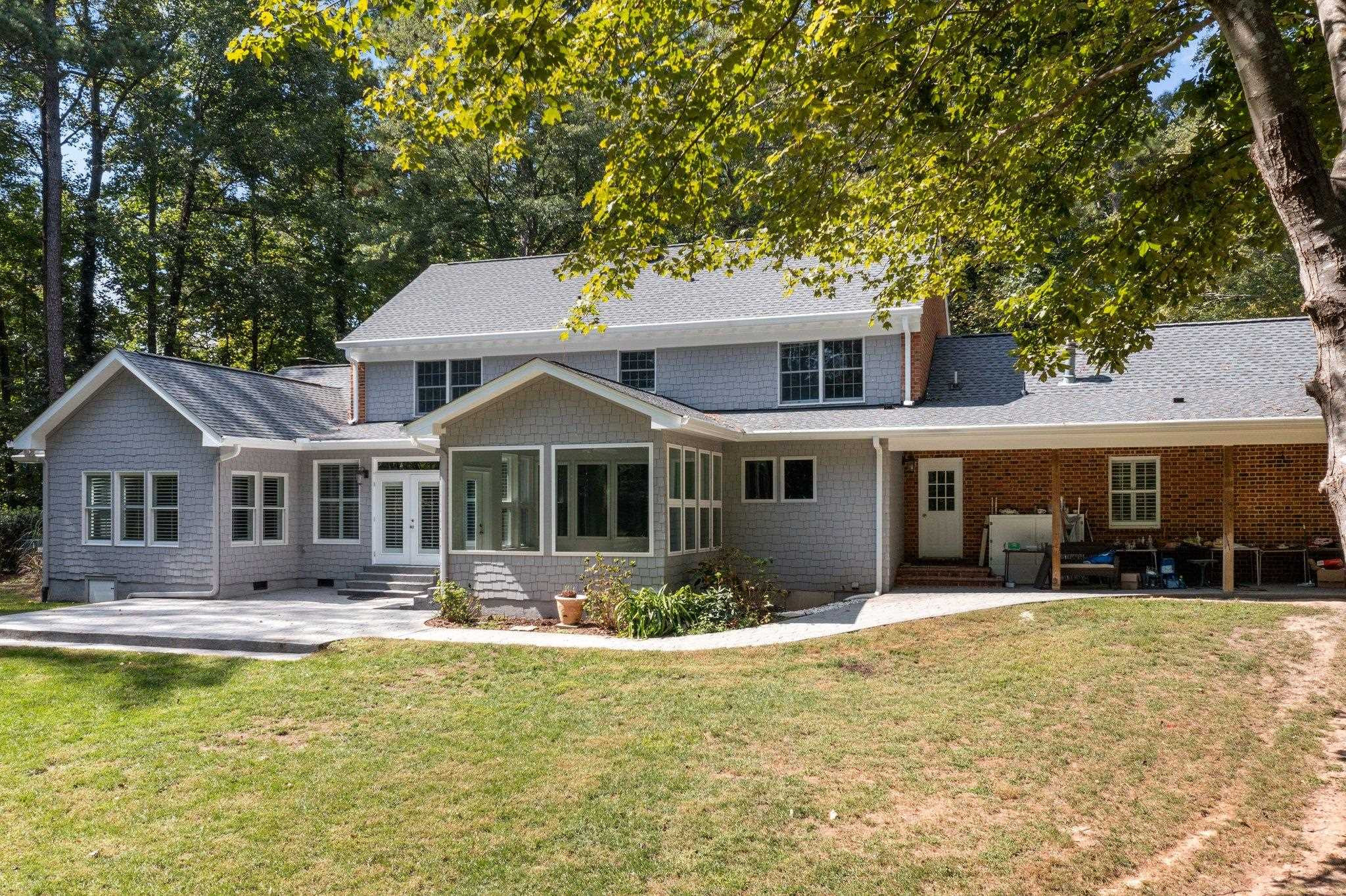 5308 Craig Road Durham, NC 27712 - Photo 8 of 46 a front view of a house with a yard table and chairs