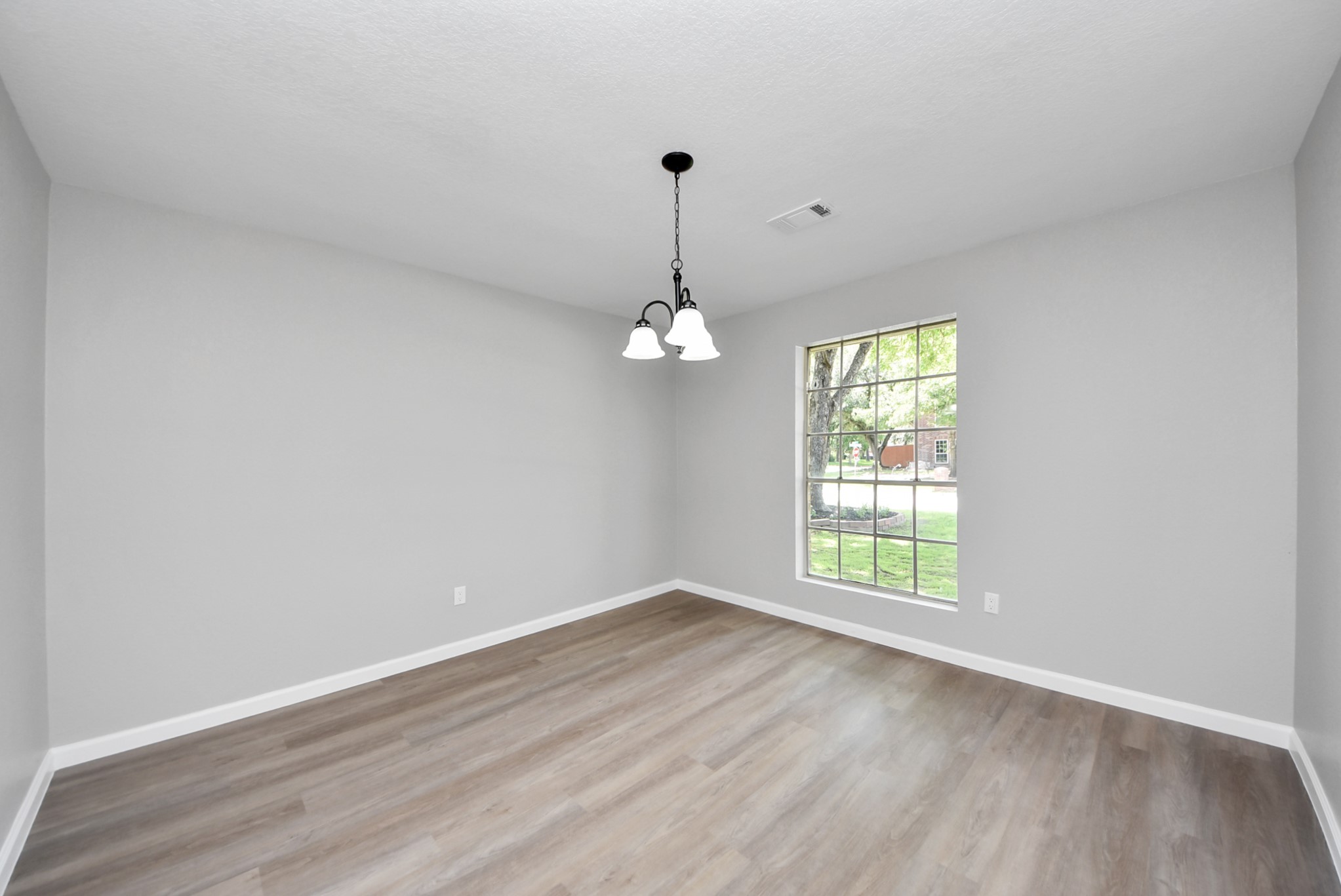 2402 Rolling Glen Drive Spring, TX 77373 - Photo 18 of 38 wooden floor in an empty room with a window