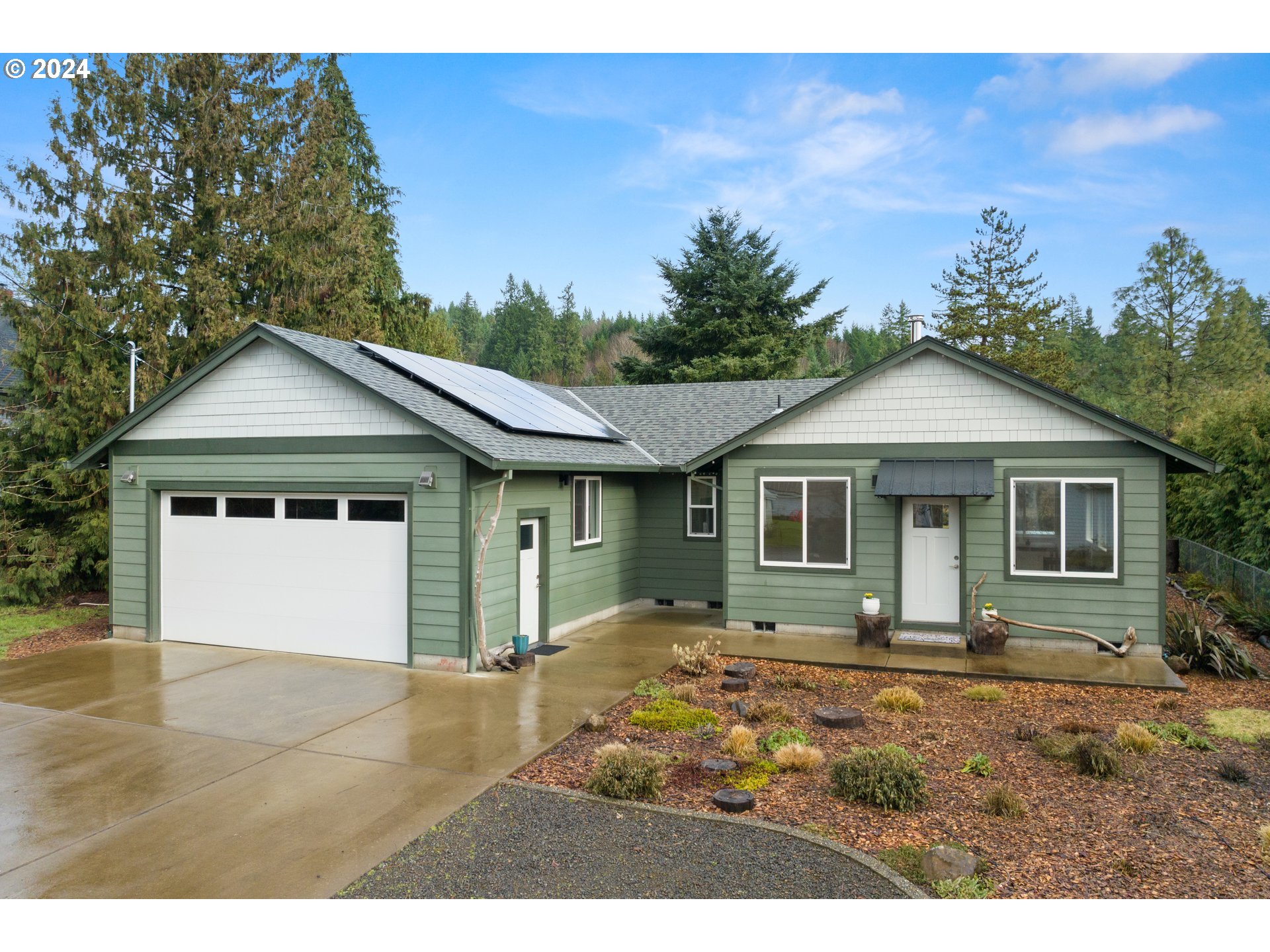 23300 Northwest Bravo Road Buxton, OR 97109 - Photo 1 of 47 a front view of a house with a garden