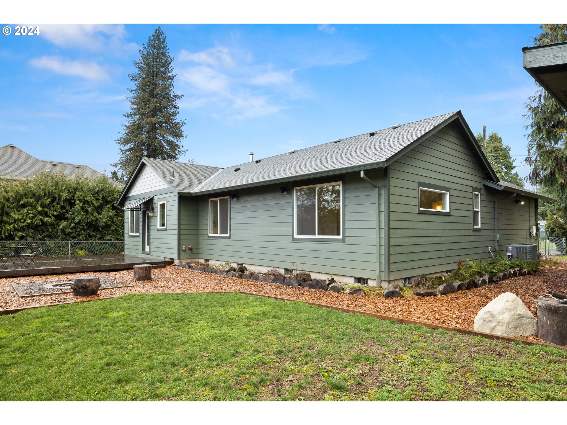 23300 Northwest Bravo Road Buxton, OR 97109 - Photo 29 of 47 a backyard of a house with table and chairs