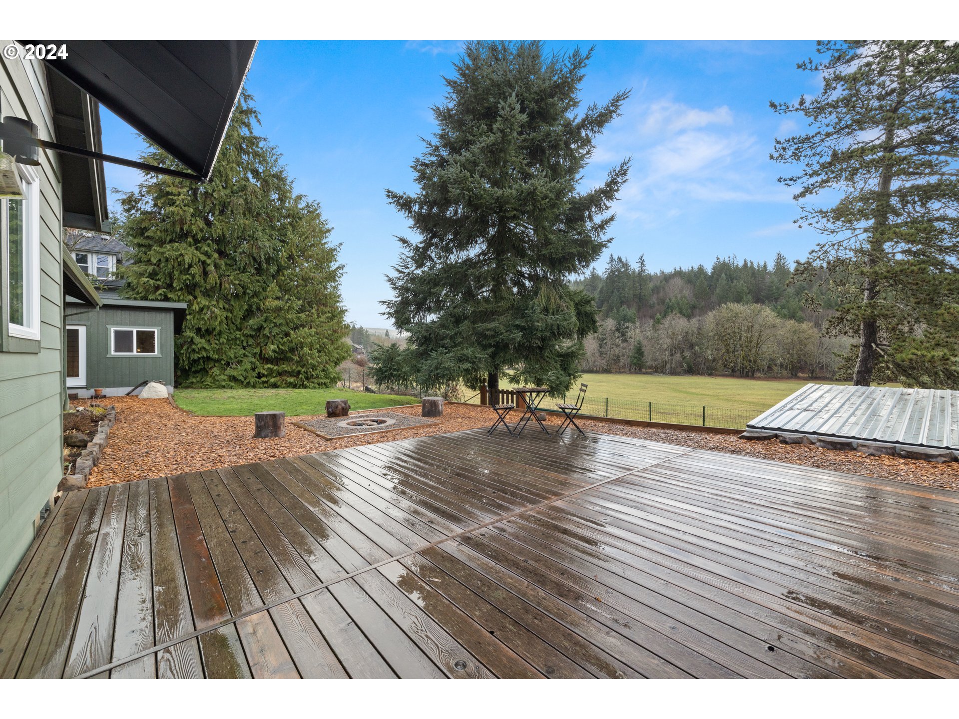 23300 Northwest Bravo Road Buxton, OR 97109 - Photo 30 of 47 a view of swimming pool with lounge chair and dinning table under an umbrella