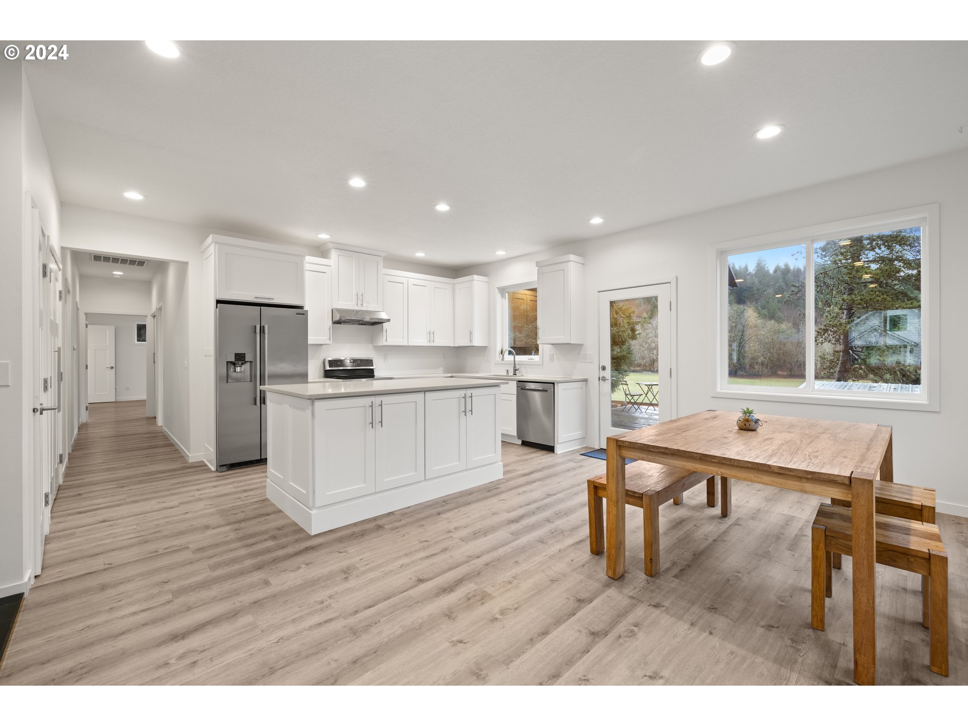 23300 Northwest Bravo Road Buxton, OR 97109 - Photo 36 of 47 a open kitchen with white cabinets and stainless steel appliances
