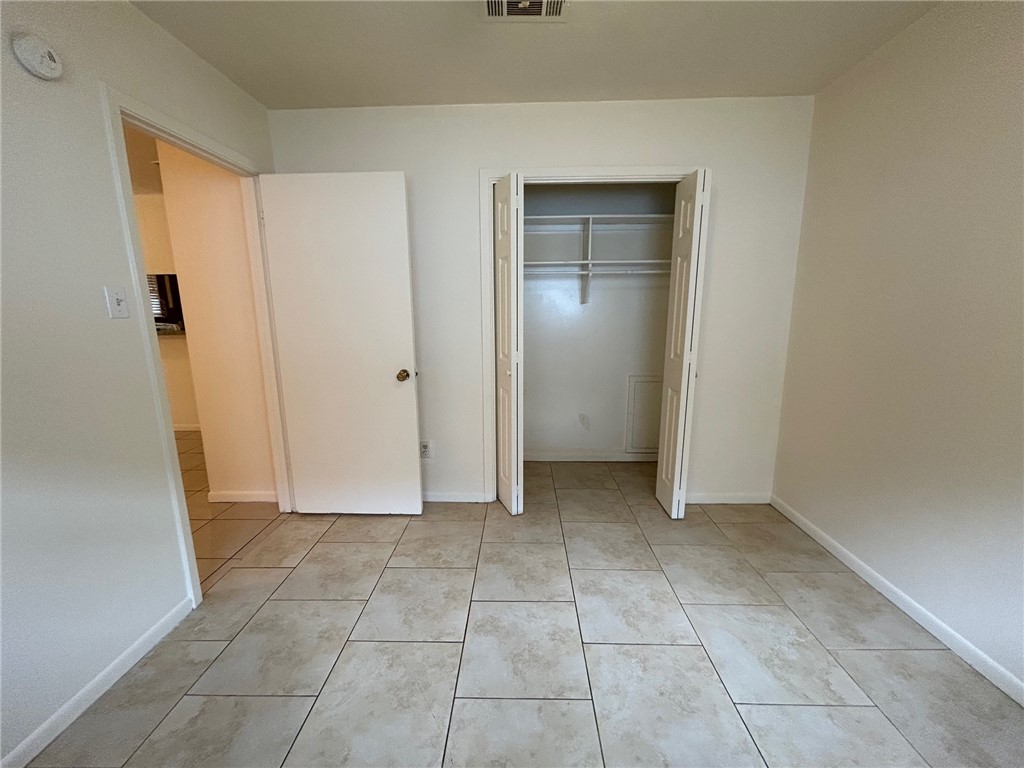 1913 Pine Tree Drive, Unit B Bryan, TX 77802 - Photo 6 of 13 an empty room with a bench and closet