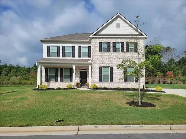 a front view of a house with a yard