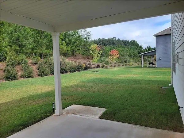 a backyard of a house with a garden and plants