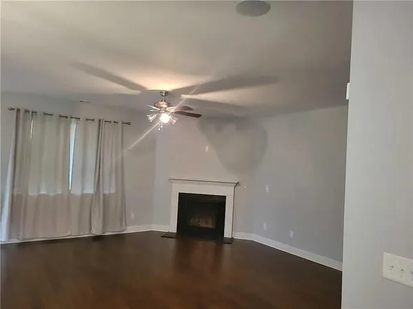 wooden floor in an empty room with a fireplace