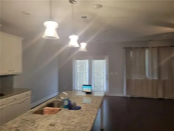 a kitchen that has a lot of cabinets and wooden floor
