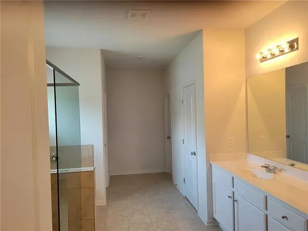 a bathroom with a double vanity sink and mirror
