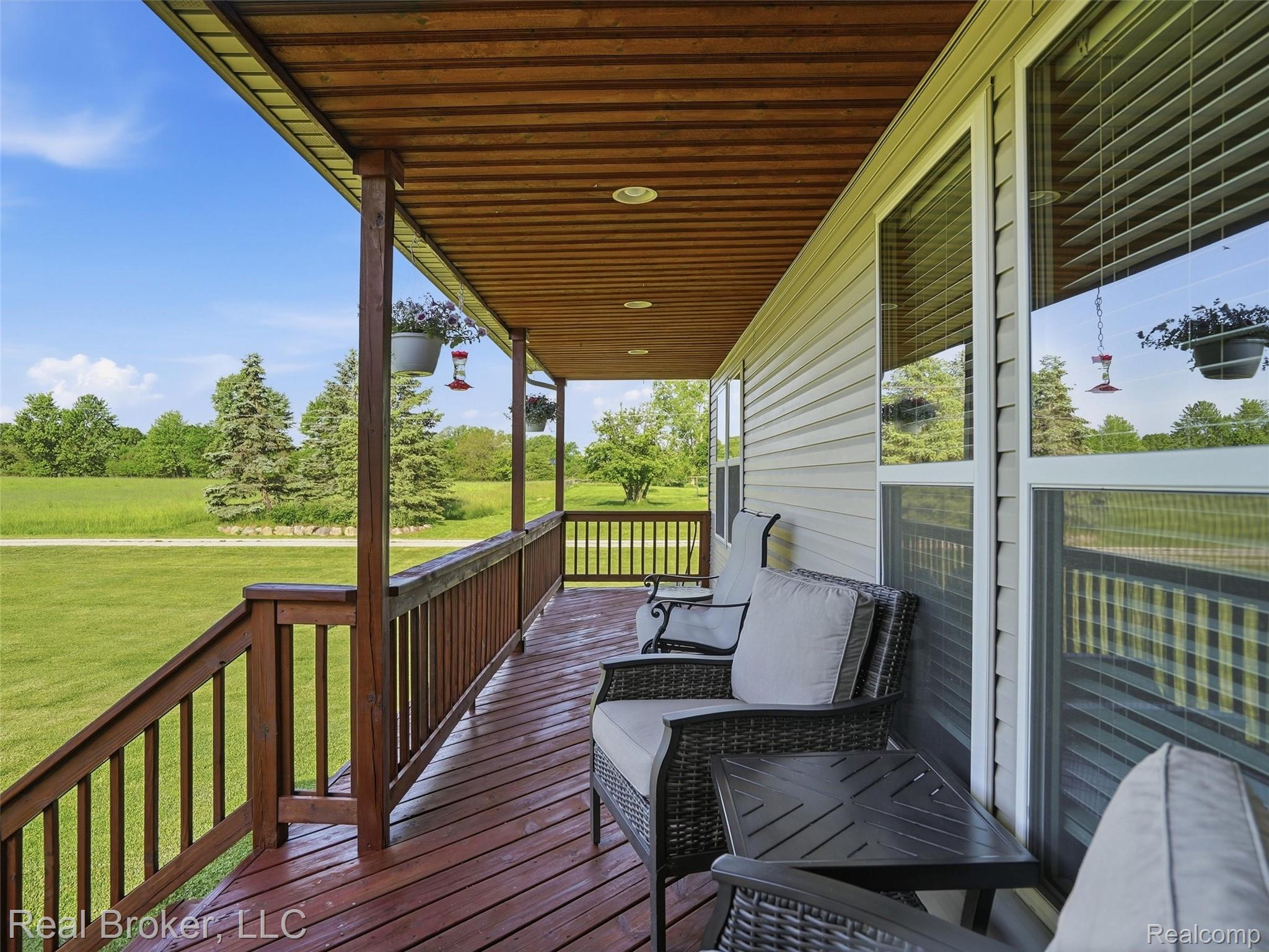 7271 West Ray Road Gaines, MI 48436 - Photo 15 of 48 Covered porch featuring a wood-finish deck and railing system