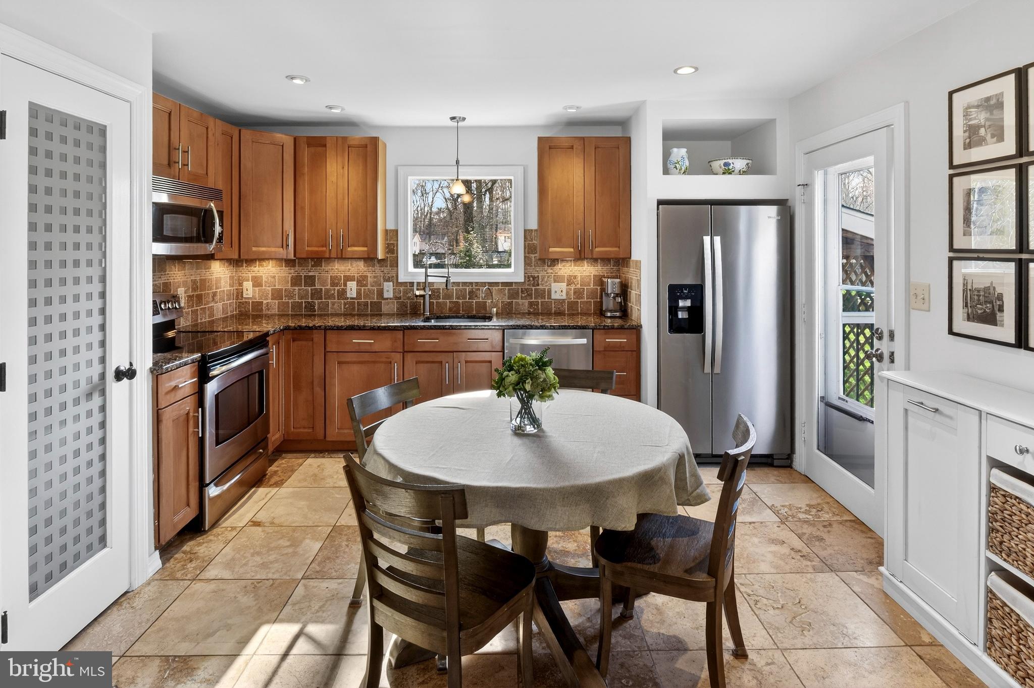 1507 Manor View Road Davidsonville, MD 21035 - Photo 5 of 45 a kitchen with stainless steel appliances granite countertop a dining table chairs refrigerator and sink