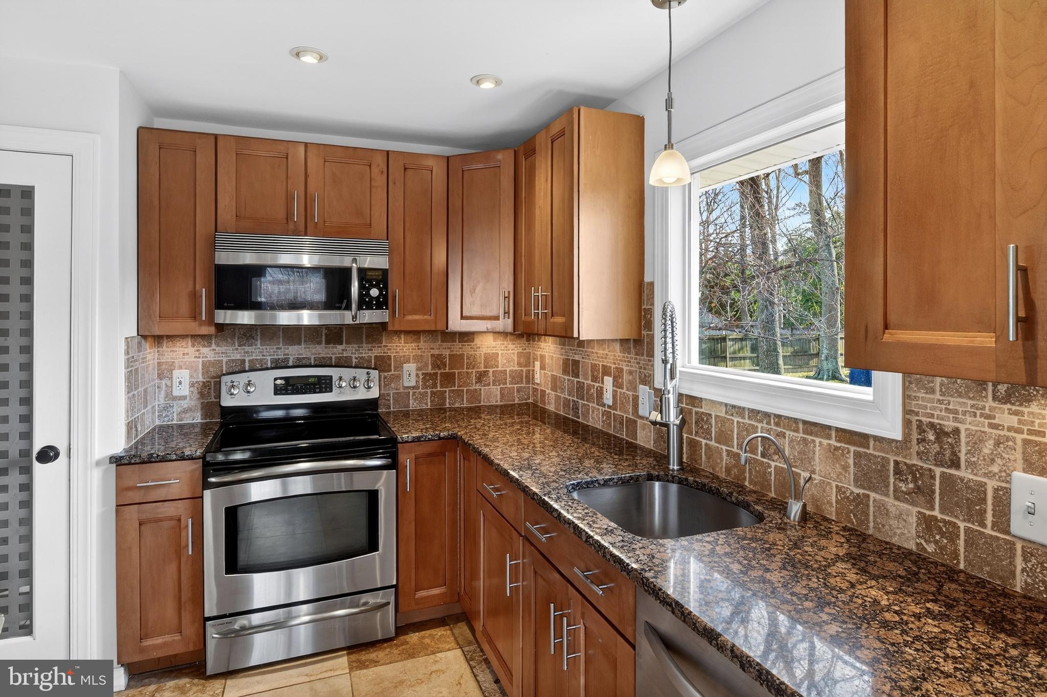 1507 Manor View Road Davidsonville, MD 21035 - Photo 6 of 45 a kitchen with granite countertop a sink a counter top space appliances and cabinets