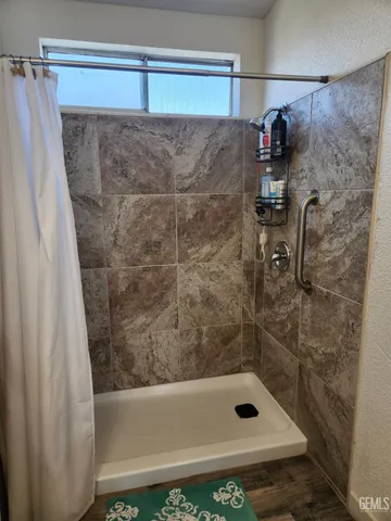 a bathroom with a shower and a sink