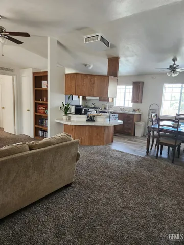 a living room with furniture and a kitchen