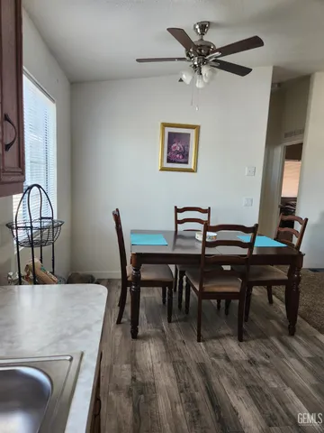 a view of a dining room with furniture and a chandelier