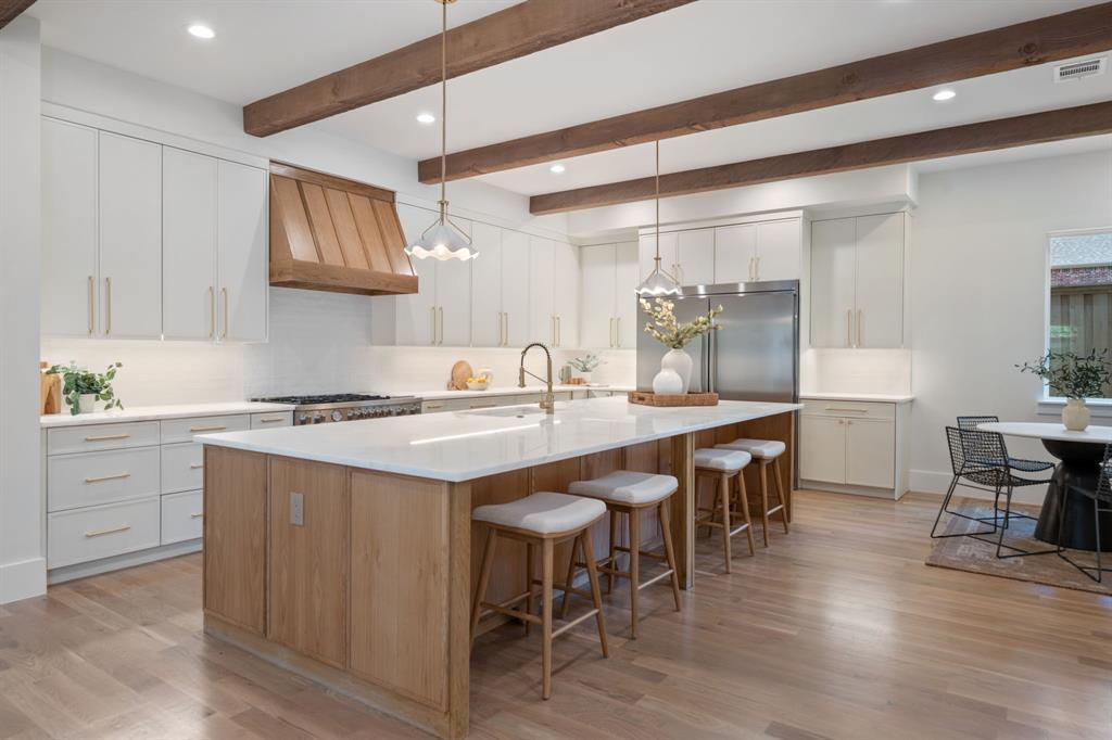 6437 Churchill Way Dallas, TX 75230 - Photo 11 of 38 a kitchen with a sink and chairs