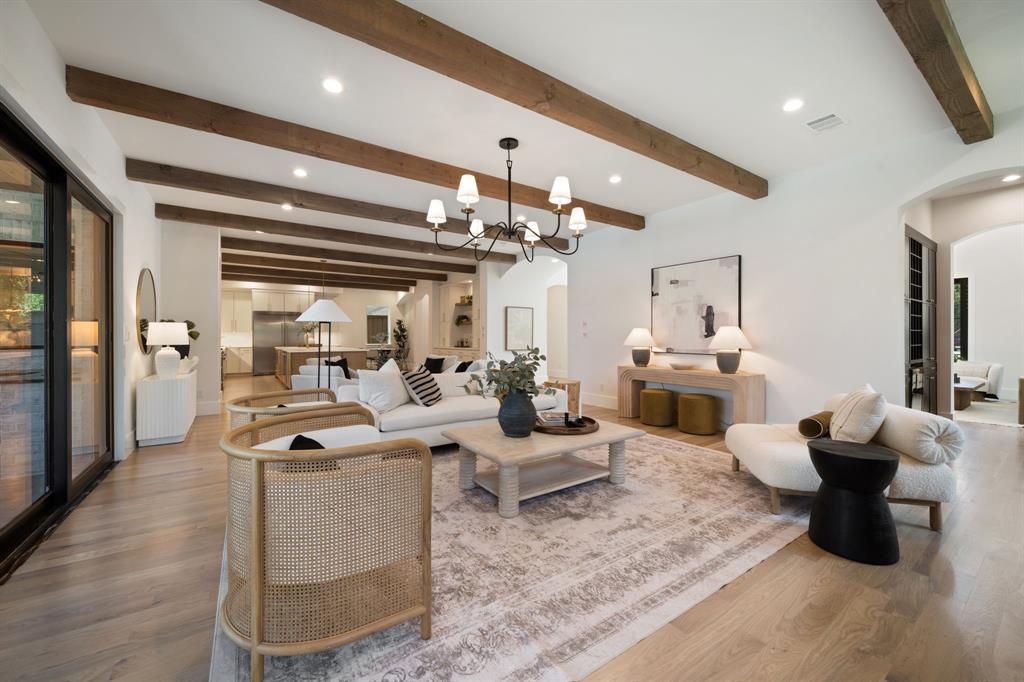 6437 Churchill Way Dallas, TX 75230 - Photo 16 of 38 a living room with furniture and a chandelier