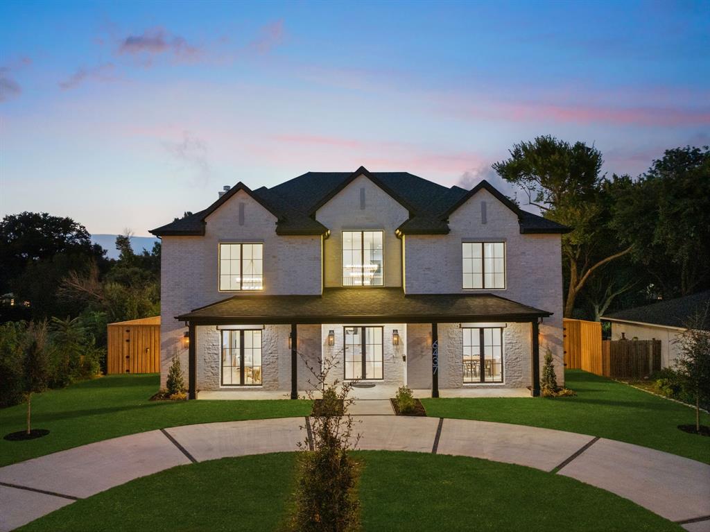 6437 Churchill Way Dallas, TX 75230 - Photo 2 of 38 a front view of a house with a yard