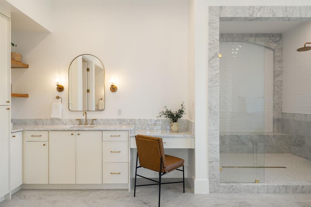 6437 Churchill Way Dallas, TX 75230 - Photo 25 of 38 a bathroom with a granite countertop sink a toilet and a mirror