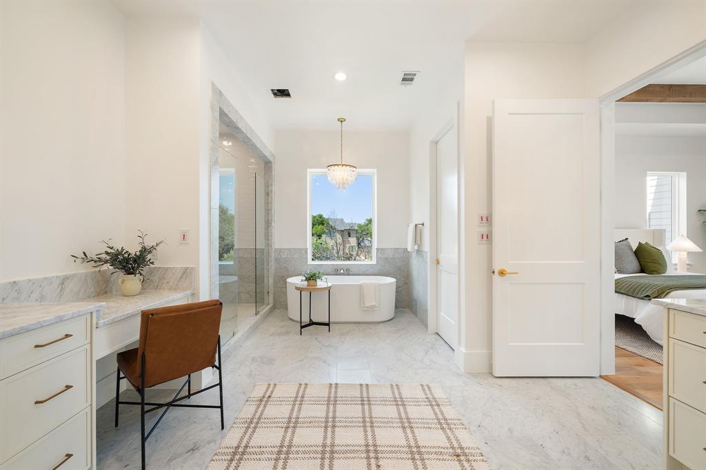 6437 Churchill Way Dallas, TX 75230 - Photo 26 of 38 a spacious bathroom with a double vanity sink and a mirror