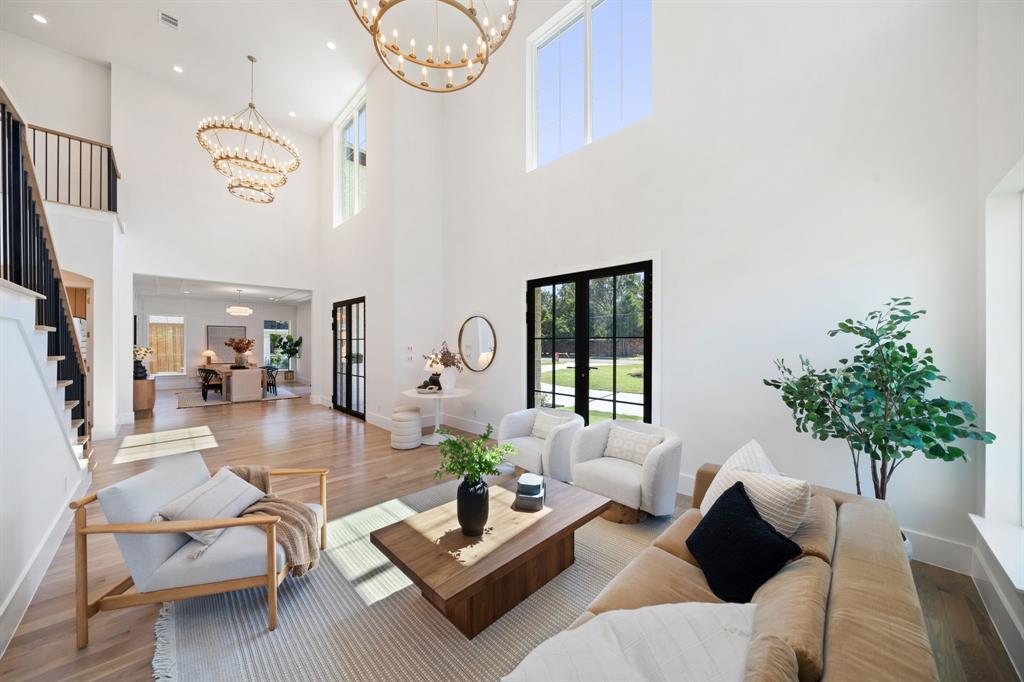 6437 Churchill Way Dallas, TX 75230 - Photo 5 of 38 a living room with furniture a chandelier and a window