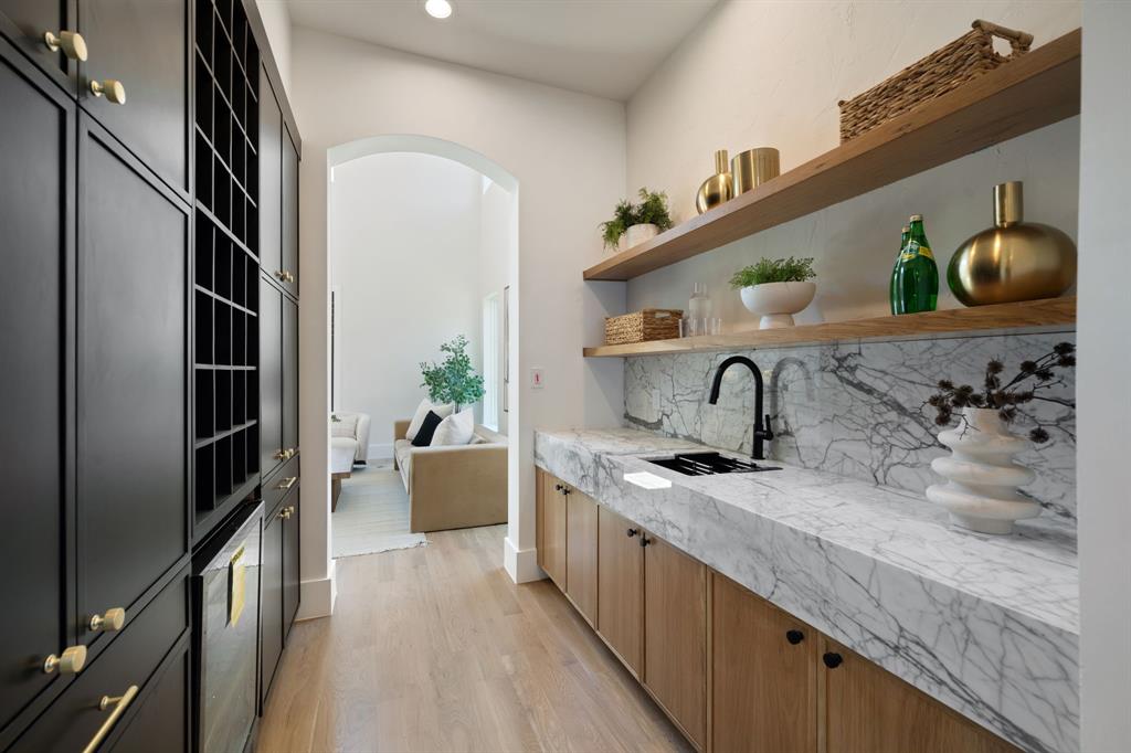 6437 Churchill Way Dallas, TX 75230 - Photo 9 of 38 a kitchen with stainless steel appliances granite countertop a sink and a refrigerator
