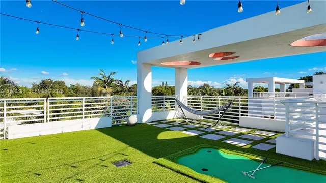 a view of a patio with a table and chairs