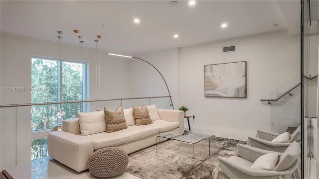 a living room with furniture and white walls