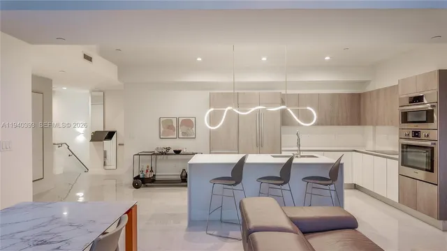 a living room with furniture a window and a chandelier