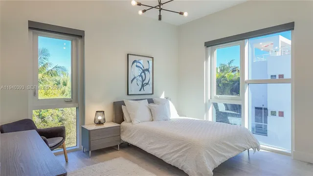 a living room with a couch and a dresser next to a window