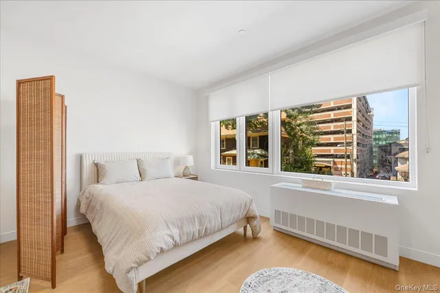 a bedroom with a bed and a large window