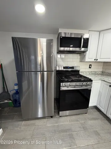 a bathroom with a sink toilet and mirror