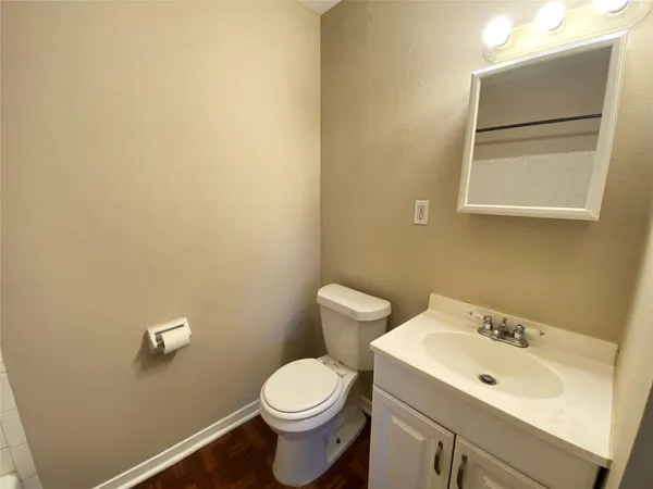 a bathroom with a sink mirror and toilet