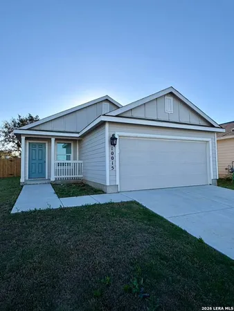 a front view of house with yard and garage