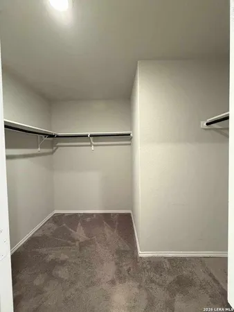 a bathroom with a granite countertop sink mirror vanity and toilet