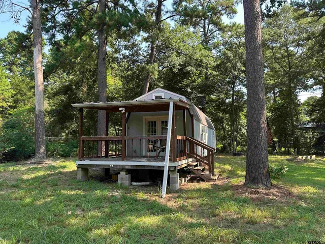 a view of a house with a yard porch and sitting area