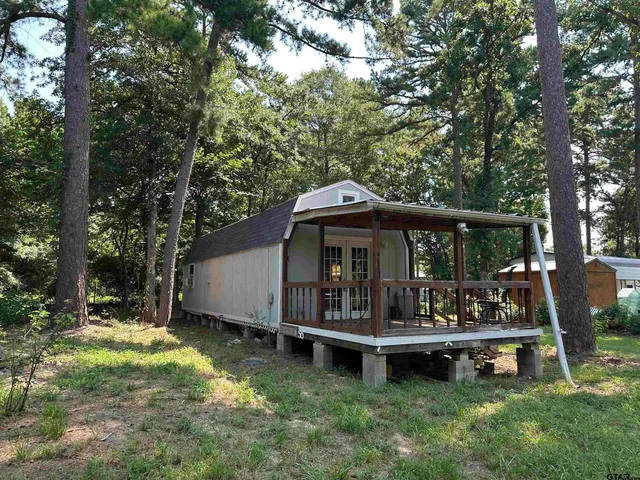 a view of a small house with a yard