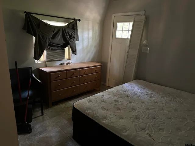 a bathroom with a toilet and a shower curtain