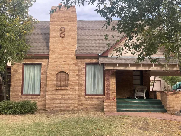 front view of a house with a tree