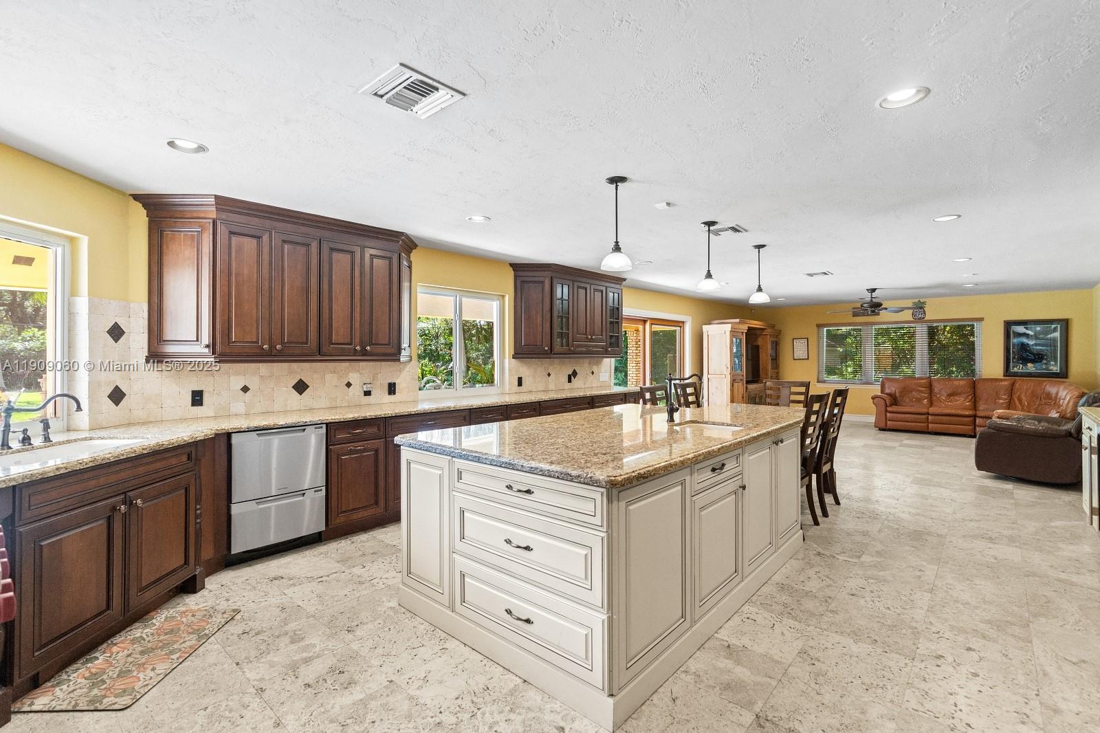 6500 Southwest 127th Street Pinecrest, FL 33156 - Photo 17 of 68 a kitchen with stainless steel appliances granite countertop a sink and cabinets