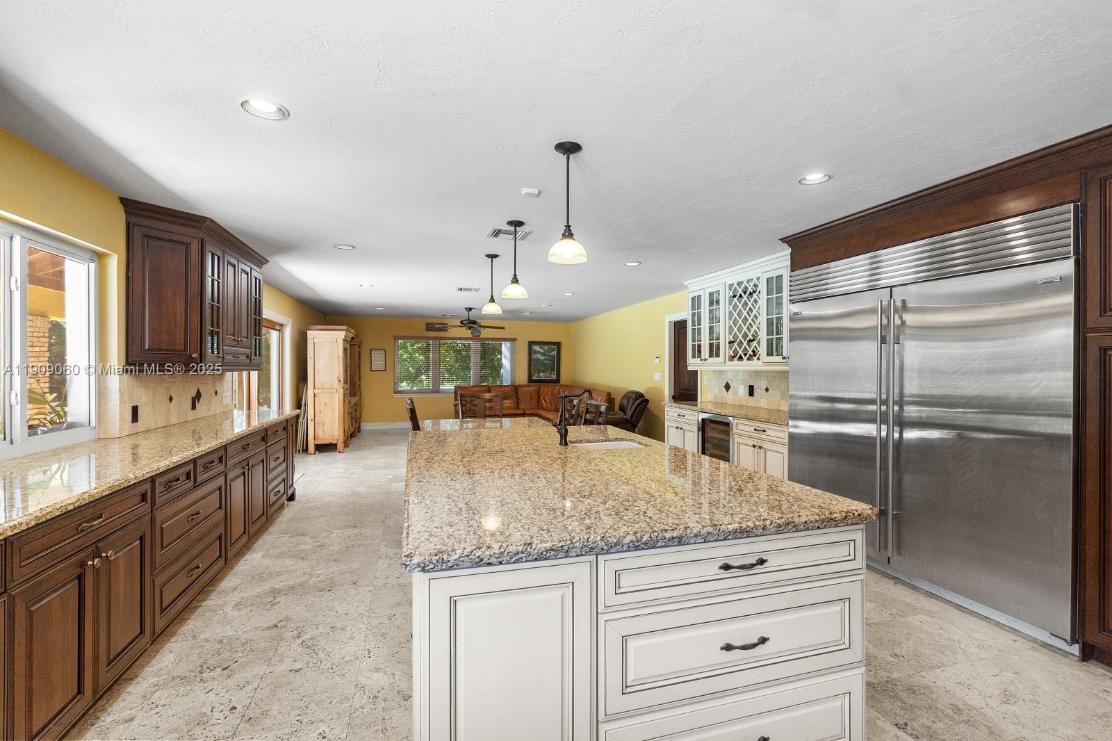 6500 Southwest 127th Street Pinecrest, FL 33156 - Photo 20 of 68 a large kitchen with kitchen island a large counter top appliances and cabinets