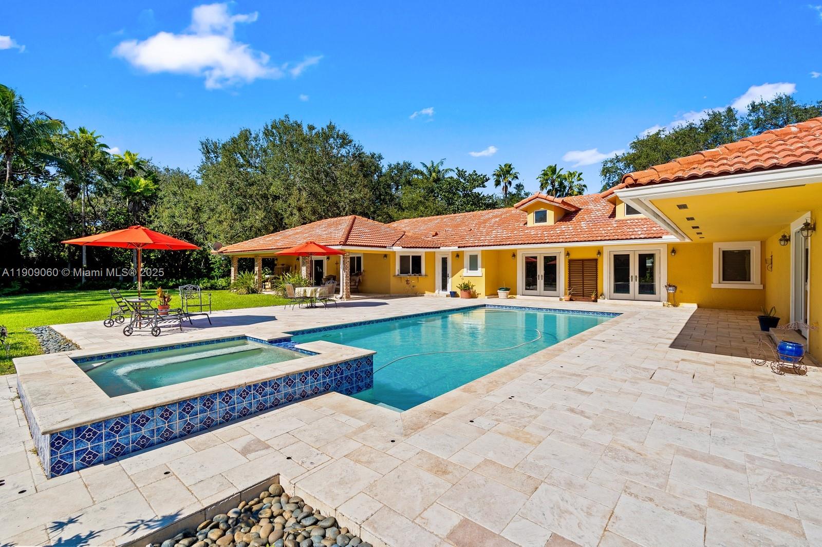 6500 Southwest 127th Street Pinecrest, FL 33156 - Photo 2 of 68 a front view of a house with swimming pool yard and outdoor seating