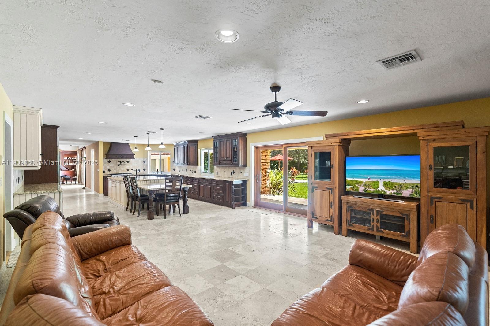 6500 Southwest 127th Street Pinecrest, FL 33156 - Photo 21 of 68 a living room with furniture and a flat screen tv