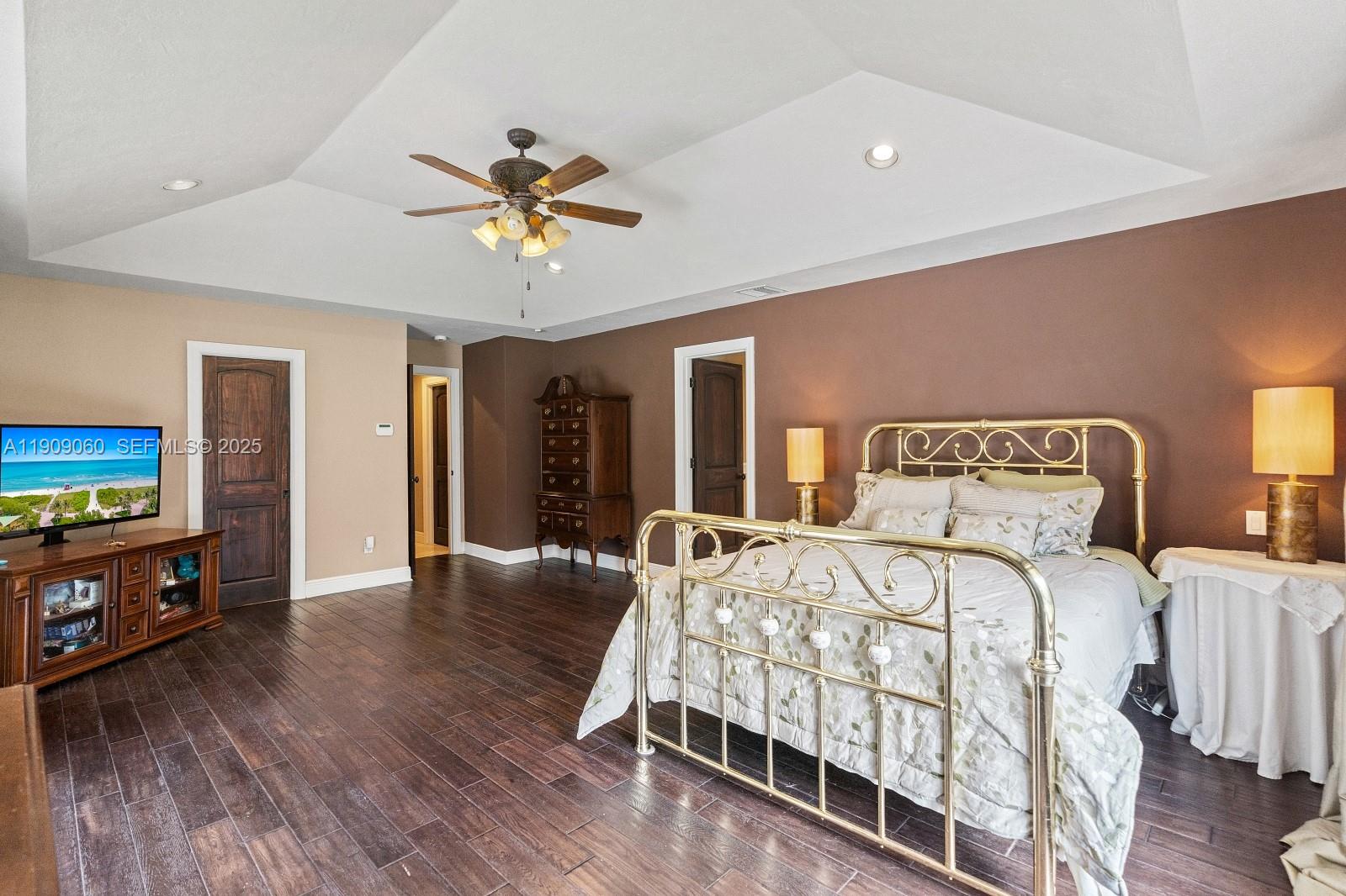 6500 Southwest 127th Street Pinecrest, FL 33156 - Photo 25 of 68 a bedroom with a bed and a flat tv screen on dresser