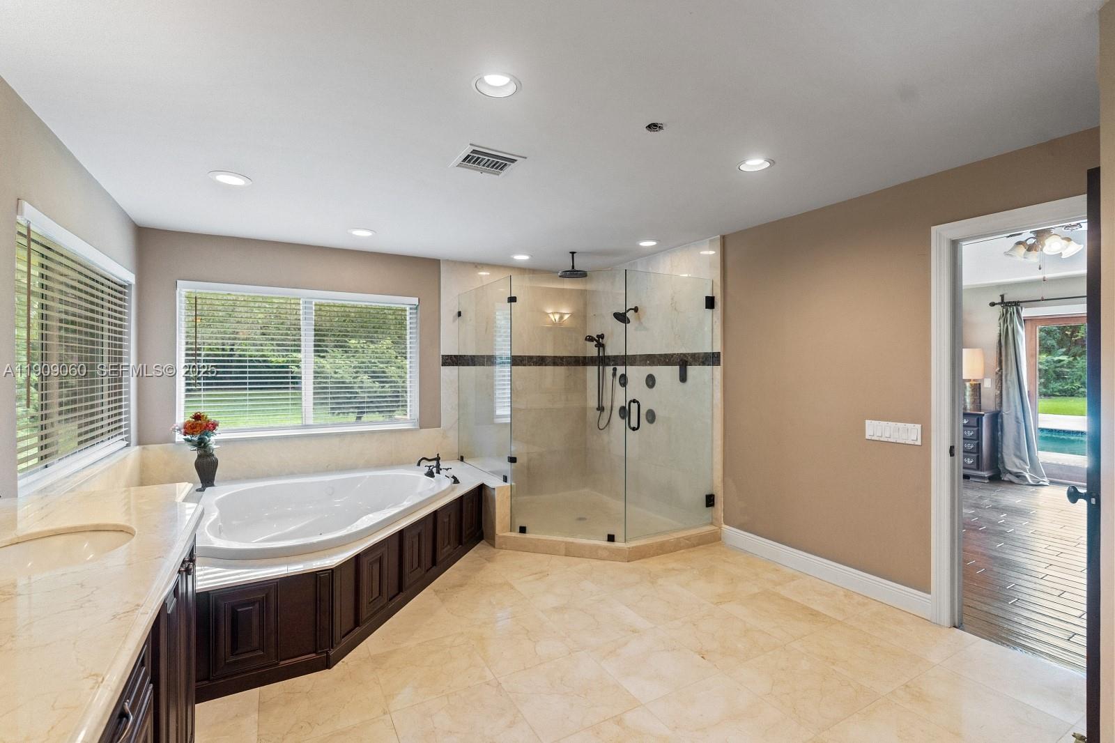 6500 Southwest 127th Street Pinecrest, FL 33156 - Photo 26 of 68 a bathroom with a tub a sink and a large window